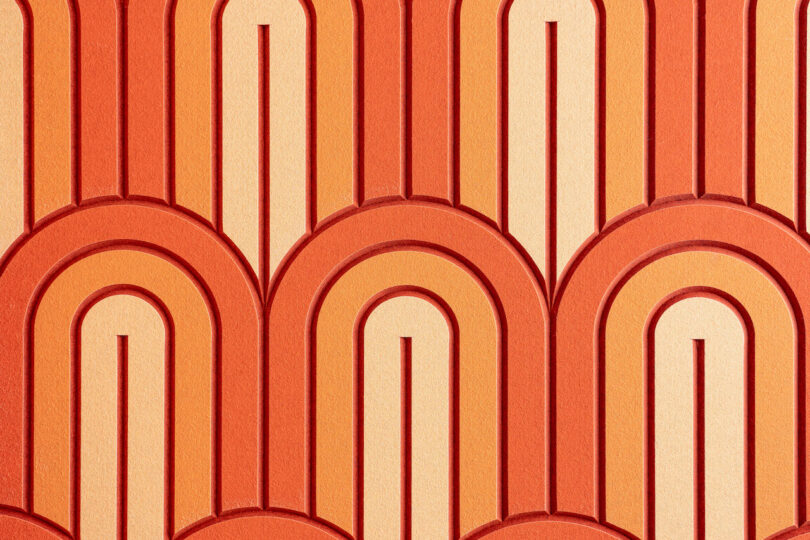 A geometric pattern of overlapping arches in varying shades of orange and red, creating a retro-style design