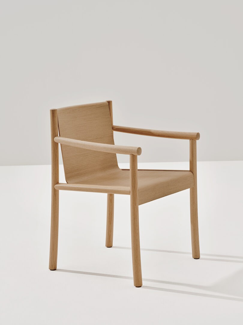 A Kata Chair by Arper with a minimalist design, featuring a flat seat and backrest, and four straight legs.