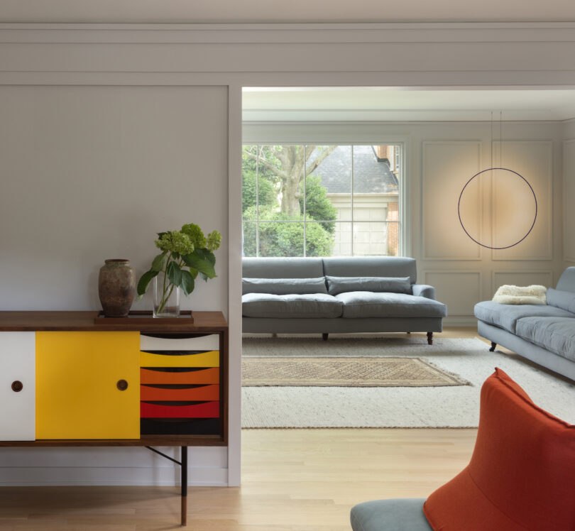 living room with circular sconce on wall