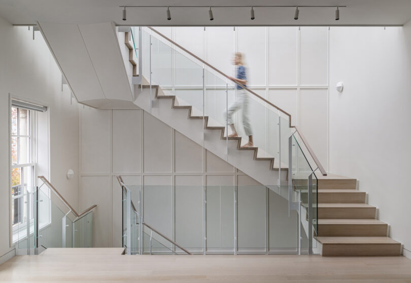 person going up stairs in modern home