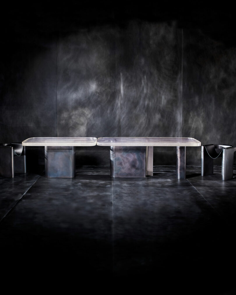 dark moody room with a glass and metal table and chairs