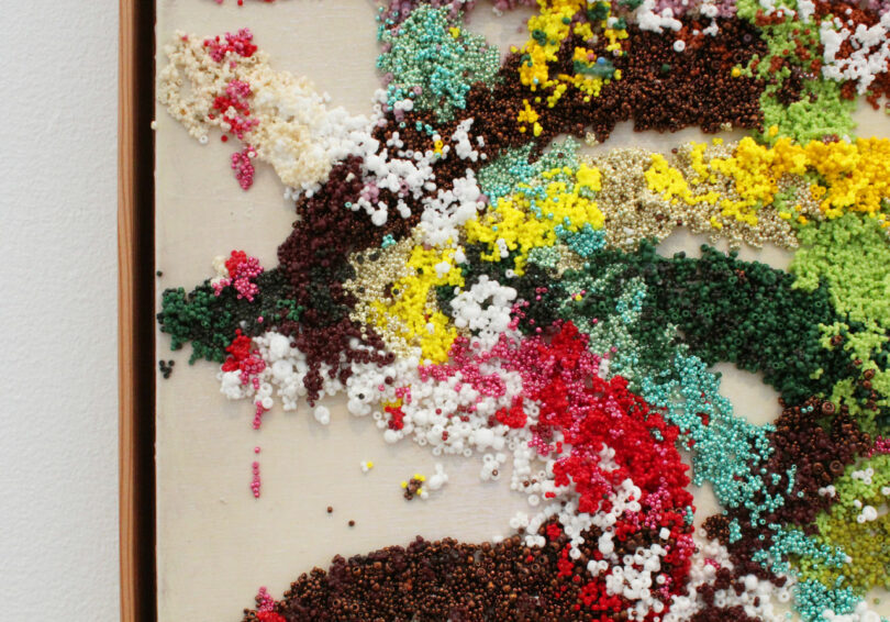 The edge of a painting made from thousands of beads