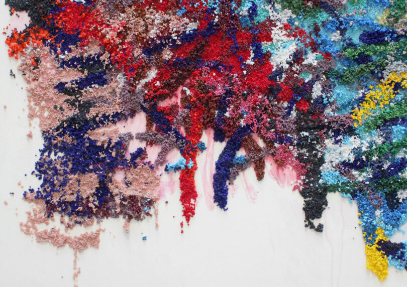 Thousands of beads resemble brushstrokes and paint drips.